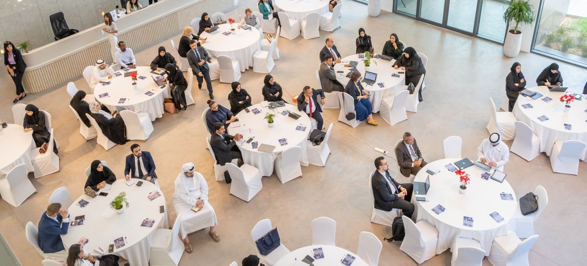 Teams working at round tables at SEE Institute